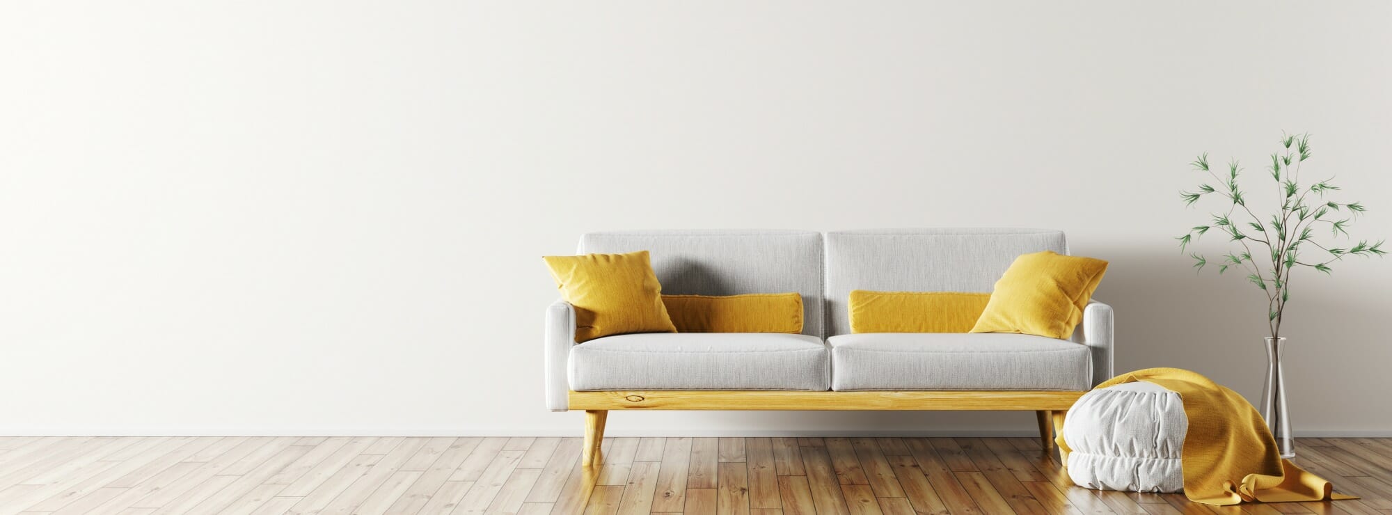 bright room with wooden floors and a grey sofa with yellow pillows